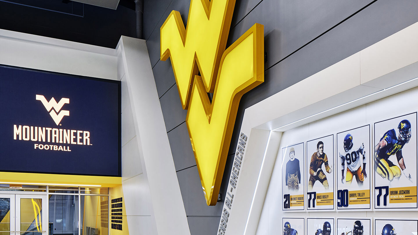 Large WV logo and all-american award winners at the West Virginia Hall of Traditions